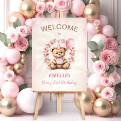 a welcome sign with pink roses and balloons