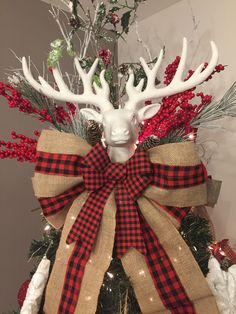 a christmas tree decorated with deer heads and burlocks