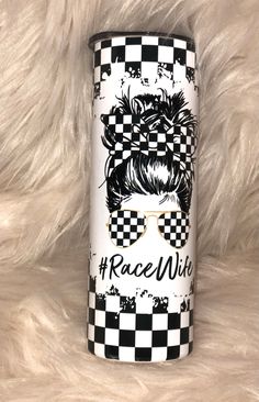 a black and white tumbler with the words race wild on it's side