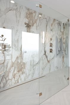 a large bathroom with marble walls and flooring