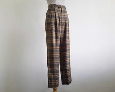 Vintage Brown Plaid Pants - Fabric : 65% polyester 35% wool - Nylon zipper on the front - Straight leg style - Pockets - Unlined - Very good vintage condition Measurements : Waist : 25" Hips : 42" Front rise : 12" Back rise : 17" Inseam : 28" Total length : 39" Width of hem : 18" Our products are vintage clothing that will be cleaned so you can be confident in the quality. We carefully inspect each garment to make sure that you get the most accurate and informed description possible. We do our best to state any imperfections in the listing. If a flaw accidentally escapes our inspection, please let me know as soon as possible and we will be happy to help remedy the situation. Please read the product description carefully before purchasing to ensure it meets your needs. If you have any quest Vintage High Waisted Pants, Brown Plaid Pants, Tartan Trousers, Pants Fabric, Pants Vintage, High Rise Pants, Brown Plaid, Plaid Pants, Pleated Pants