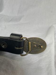 "You are looking at a genuine black leather bag from Kangol. Belt measures 35\"5 long, 1\"2 wide, measuring 26\" in the only perforation from buckle. Belt comes with aged brass tone hardware with great detail and strong leather. 100% genuine Kangol and belt is a great vintage find. I want to stress that item is vintage which means it's not new. All my customers are very important to me and I believe communication is very important. I do not sell or encourage any one to sell fakes. Not responsibl Bell Gardens, Black Leather Bag, Brown Leather Belt, Black Leather Belt, Black Leather Bags, Logo Black, Buckle Belt, Aged Brass, Vintage Finds