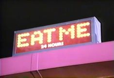 a neon sign that says eat me on it