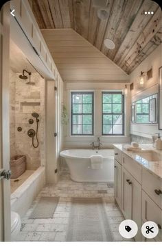 a bathroom with a tub, sink and window