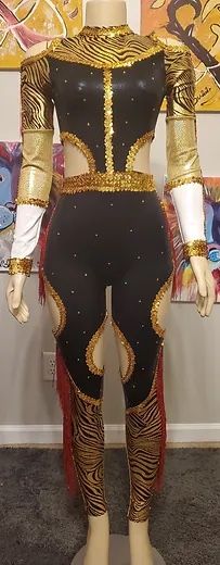 a mannequin is dressed in gold and black