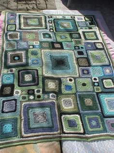 a crocheted blanket with squares on it