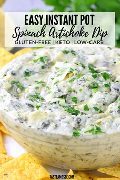 a white bowl filled with spinach artichoke dip surrounded by tortilla chips