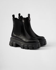 Upper with elasticized side gussets and pull tab Leather lining Enameled metal triangle logo Boot Leg: 16 cm Rubber sole, 55 mm Lug tread Removable leather-covered insole Prada Chelsea Boots, Leather Chelsea Boots Women, Prada Monolith, Prada Boots, Ballerina Slippers, Luggage Bags Travel, Modern Shoes, Mens Travel Bag, Chelsea Boots Women