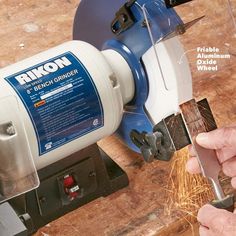 a person using a grinder to cut wood with a circular sawtoothing tool