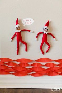 two elfs are hanging on the wall