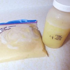 a bag of dough next to a bottle of milk on a counter top with writing on it