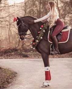 a woman riding on the back of a brown horse