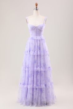 a purple dress on a mannequin headdress with ruffles and straps