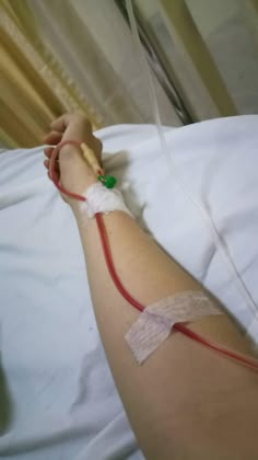 a person laying in bed with an iv attached to their arm