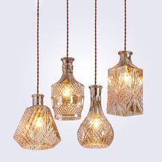 three glass vases hanging from strings with lights on them and the words, lonkoey