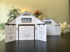 a paper cut out of a house with lights on the front and back sides, sitting on top of a table