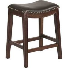 the backless stool is made from wood and has brown leather upholstered seat