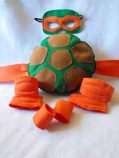 a turtle made out of orange tape and wearing a mask