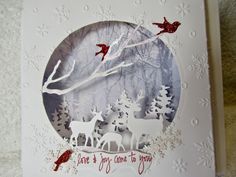 a christmas card with reindeers and birds on it