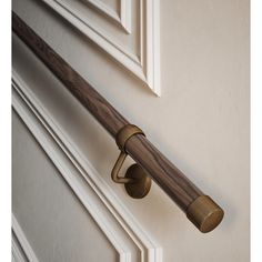 a wooden handle on a white door