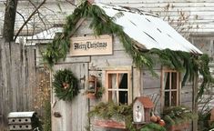 a small wooden house with christmas decorations on the roof