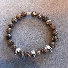 "Handmade with 8mm natural Turritella agate and sterling silver skulls on quality stretch cord. Great for everyday wear. Natural Turritella agate beads and sterling silver skulls were used in this bracelet. Any toggles, clasps, or othersilver beads are sterling silver. Bracelet length information: Stretchy bracelets will fit 7-7.5\"inch wrists. PLEASE REACH OUT WITH QUESTIONS OR FOR CUSTOM ORDERS. THANKS FOR VISITING MY SHOP AND PLEASE CHECK OUT THE OTHER AVAILABLE ITEMS" Turritella Agate, Stretchy Bracelets, Sterling Silver Bracelet, Agate Beads, Custom Orders, Silver Bracelet, Agate, Jewelry Bracelets, Everyday Wear