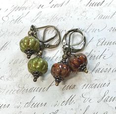 I love these rustic Pumpkin Earrings . They are Czech glass pumpkin/melon beads that come in a spice color or a  green. The brownish ones are kind of a rusty orange maybe more of a spice color with swirls of olive green . The green are kind of like a Granny Smith apple. They definitely have an Autumn feel to them. I've paired them with antiqued brass beads to complete the warm Autumn feel. They are approximately 1.5 inches long and come in a gift box or gift bag. Rustic Green Earrings For Gifting, Rustic Green Earrings For Gift, Pumpkin Jewelry, Granny Smith Apple, Autumn Jewelry, Rustic Pumpkin, Lampwork Jewelry, Rusty Orange, Brown Earrings