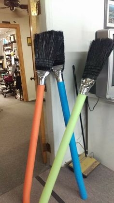 two brooms sitting next to each other on the floor