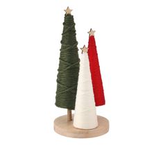 two small christmas trees on wooden base with red and white yarn wrapped around them, one is green and the other has gold stars