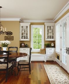 a dinning room table and chairs in front of a window