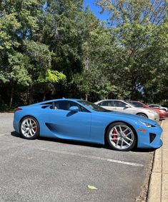 a blue sports car parked in a parking lot