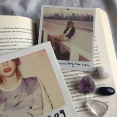 an open book with two pictures on top of it and some rocks next to it