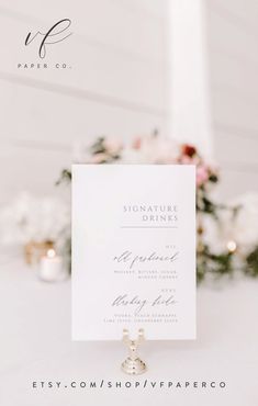 a white table topped with flowers and a sign that says signature dining on top of it