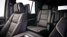 the interior of a truck with black leather and gray stitching on the front seats