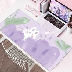 a laptop computer sitting on top of a desk next to a mouse pad and keyboard