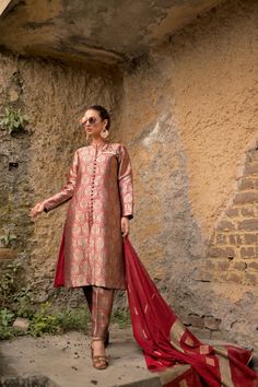 Obaid Sheikh Exclusive CollectionA structured, Mughal-inspired, pure atlas sherwani in a spice red color. Paired with a khadi silk dupatta and hand-embroidered brooch detail. All in all, a truly regal look. Elegant Sherwani In Raw Silk With Straight Kurta, Elegant Raw Silk Sherwani Straight Kurta, Elegant Semi-stitched Raw Silk Sherwani, Festive Raw Silk Lawn Suit With Traditional Drape, Elegant Raw Silk Sherwani With Dabka Detailing, Ceremonial Raw Silk Sherwani With Naqshi, Ceremonial Naqshi Sherwani In Raw Silk, Red Naqshi Traditional Wear For Wedding, Elegant Semi-stitched Silk Sherwani