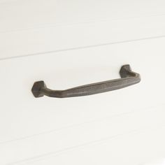 an old metal handle on a white door