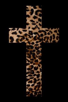 a cross made out of leopard print on a black background