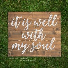 a wooden sign that says it's well with my soul on the grass in front of