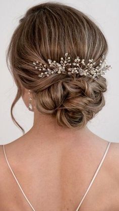 the back of a woman's head wearing a bridal hair piece