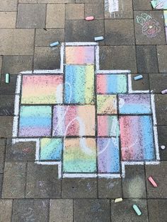 chalk drawings on the ground with crayons and pastel pencils in it