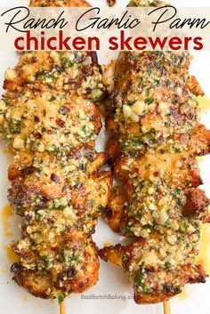 grilled chicken skewers on a white plate with text overlay that reads ranch garlic parm chicken skewers