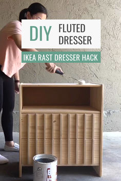 a woman standing next to a wooden dresser with the words diy painted on it