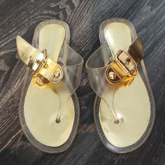 Brand New. Super Cute Sandals! Clear Part May Need To Be Shined Up A Bit, But They Are In Perfect Condition. Gold Flat Synthetic Jelly Sandals, Gold Flat Jelly Sandals, Gold Jelly Sandals With Round Toe For Spring, Gold Synthetic Jelly Sandals For Beach, Gold Jelly Sandals For Beach And Spring, White Wedge Shoes, Plastic Sandals, Clear Sandals, Brown Wedge Sandals