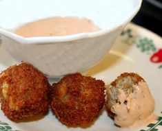 three crab cakes on a plate next to a bowl of dip and sauce with the words all things food - cooking with mary and friends