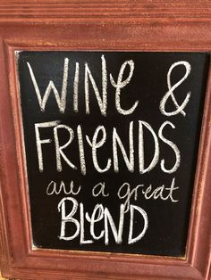 a chalkboard sign that says wine and friends are a great blend