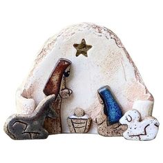 a nativity scene is shown with two animals and a star on the top of it