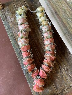 an arrangement of flowers arranged in the shape of a letter v on a wooden table