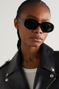 CELINE Eyewear's sunglasses have been made in Italy from black acetate and have modern oval-shaped frames. They're adorned with an archival logo plaque - first introduced by the label's founder in 1973 - and fitted with dark lenses. Celine Oval Sunglasses, Sunglasses Shoot, Celine Eyewear, Celine Triomphe, Celine Sunglasses, Acetate Sunglasses, Ballet Pumps, Oval Sunglasses, Eyewear Womens