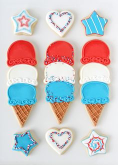 decorated cookies arranged in the shape of ice cream cones and stars, with red white and blue icing